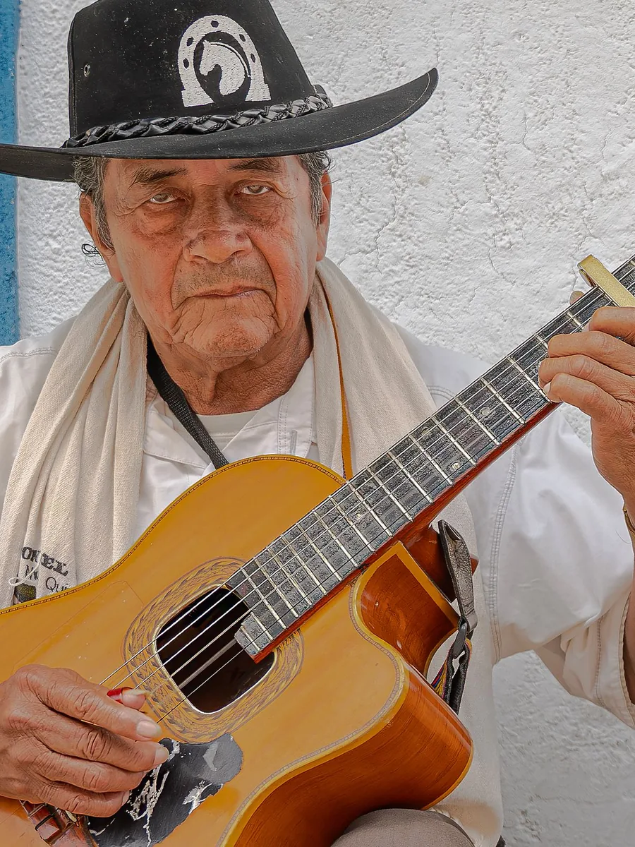 An acoustic guitar player performing outdoors